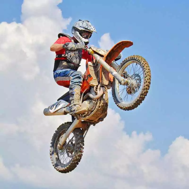 Man performing motorcycle tricks in the air