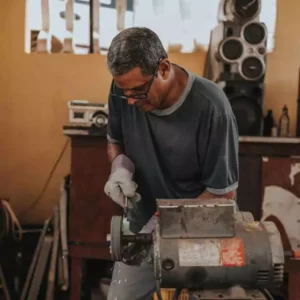 Middle-aged man polishing parts